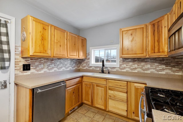 kitchen with backsplash, sink, light tile patterned floors, and stainless steel appliances