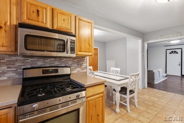 kitchen featuring decorative backsplash and stainless steel appliances