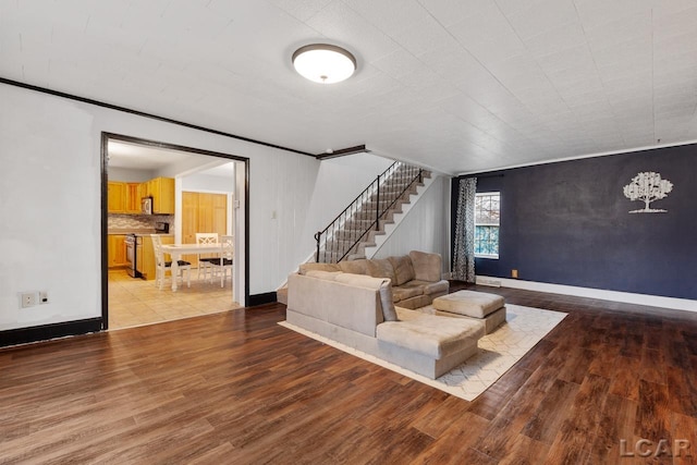 unfurnished living room featuring light hardwood / wood-style flooring and ornamental molding