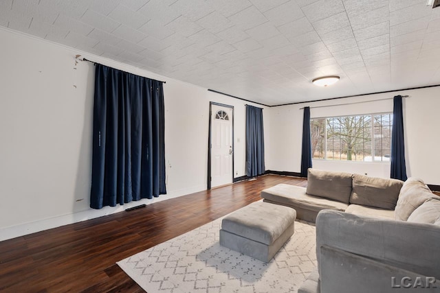 living room with ornamental molding and hardwood / wood-style flooring