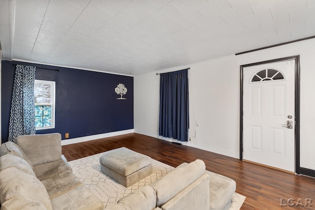 living room with hardwood / wood-style flooring and crown molding