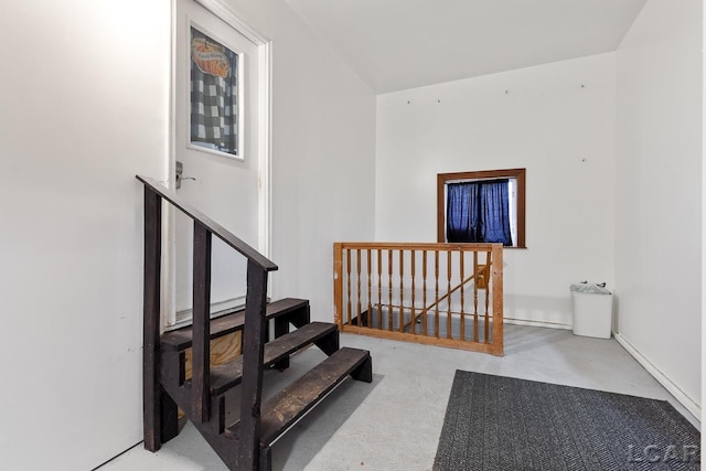 staircase featuring concrete flooring