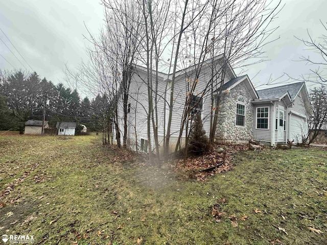 view of property exterior with a storage shed and a yard