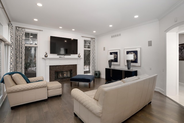 living room with dark hardwood / wood-style floors, a high end fireplace, and ornamental molding