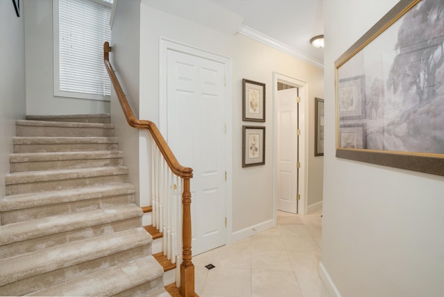 staircase featuring tile patterned flooring and ornamental molding