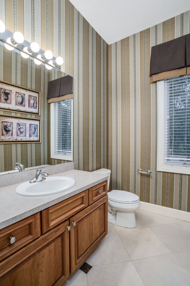 bathroom with toilet, tile patterned floors, and vanity