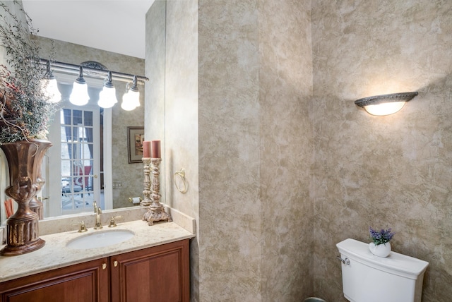 bathroom featuring toilet and vanity