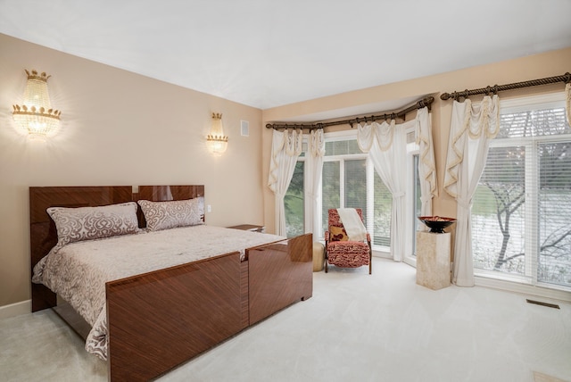 bedroom featuring carpet floors and multiple windows