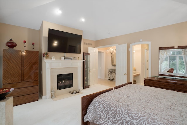 bedroom featuring light colored carpet, a notable chandelier, and connected bathroom