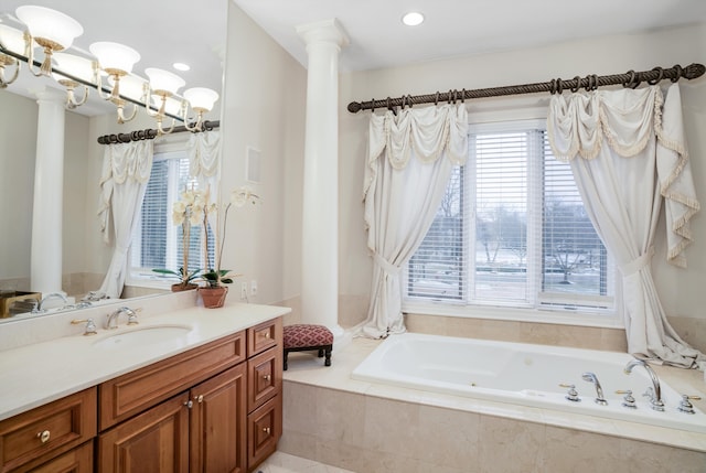 bathroom with tiled bath and vanity