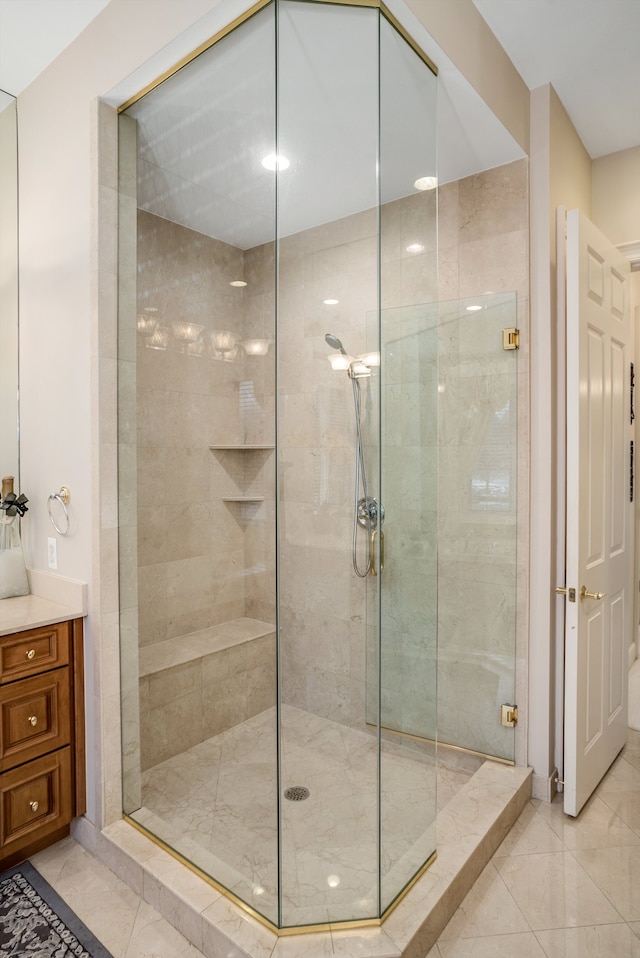 bathroom with an enclosed shower and tile patterned flooring