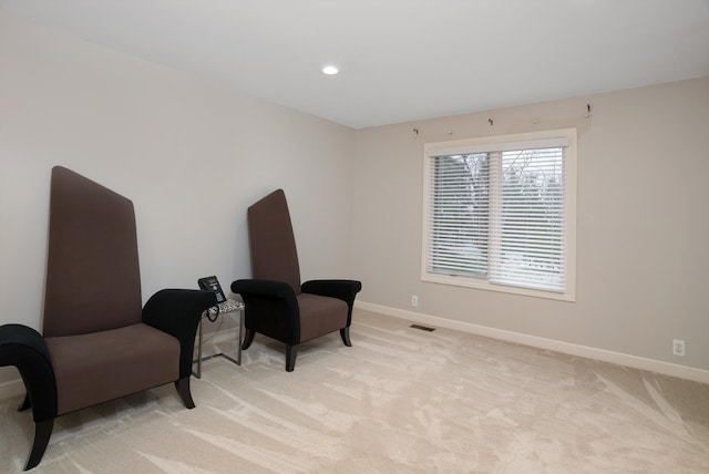 living area with light colored carpet