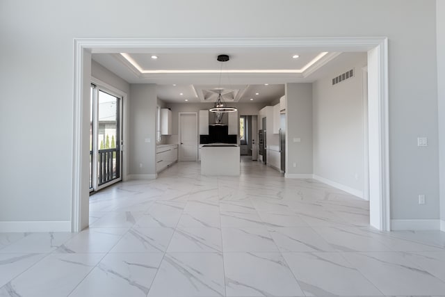 4380 The Heights Blvd, Rochester, MI 48306 - interior space with white cabinets, an inviting chandelier, hanging light fixtures, and a tray ceiling
