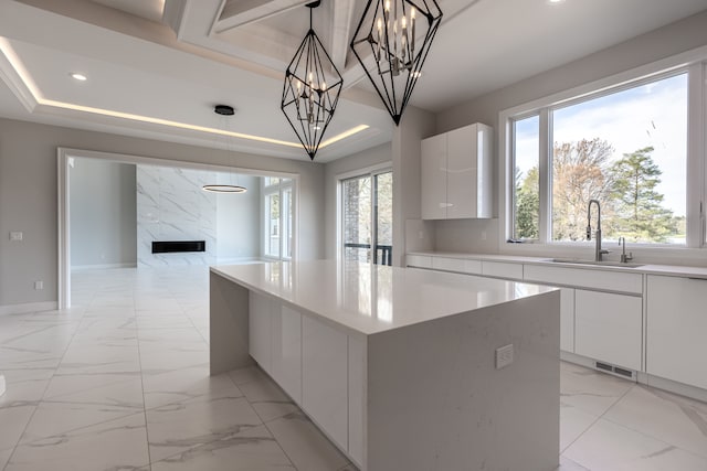 4380 The Heights Blvd, Rochester, MI 48306 - kitchen featuring white cabinets, pendant lighting, a kitchen island, and sink