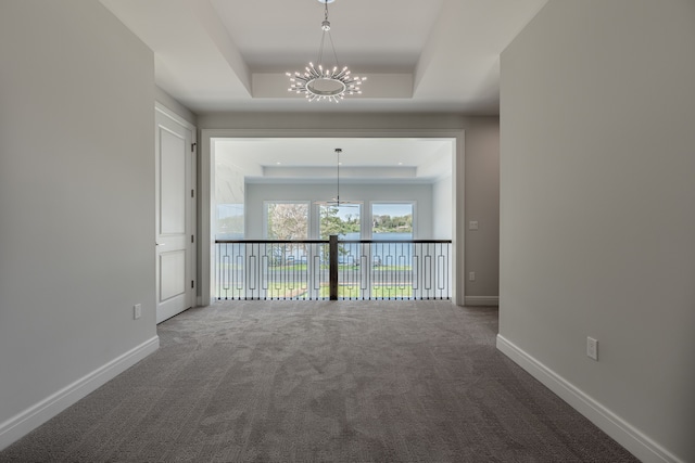 4380 The Heights Blvd, Rochester, MI 48306 - interior space featuring a tray ceiling, carpet floors, and an inviting chandelier