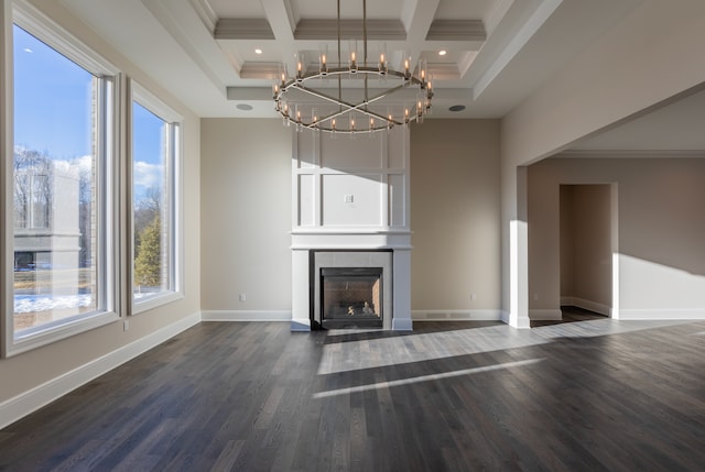 unfurnished living room featuring dark wood-style floors, ornamental molding, baseboards, coffered ceiling, and a fireplace