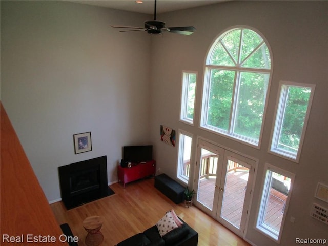 living room with ceiling fan and light wood-type flooring