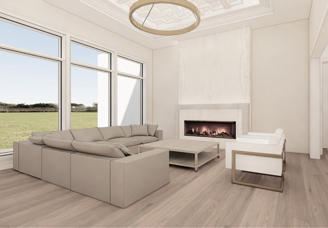 living room with plenty of natural light, light hardwood / wood-style floors, ornamental molding, and a fireplace