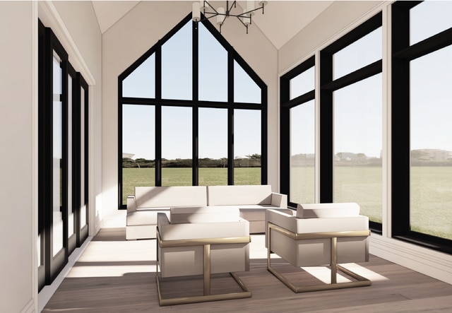 sunroom / solarium featuring lofted ceiling and a wealth of natural light