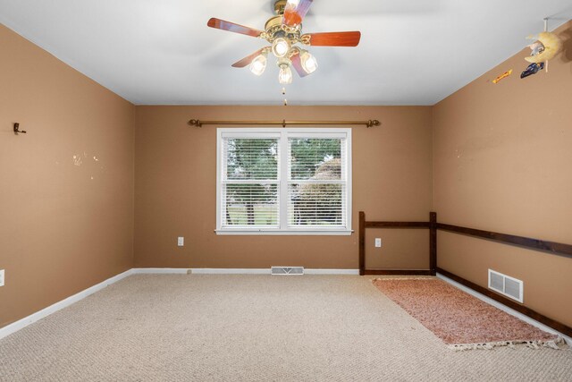 empty room with carpet floors and ceiling fan