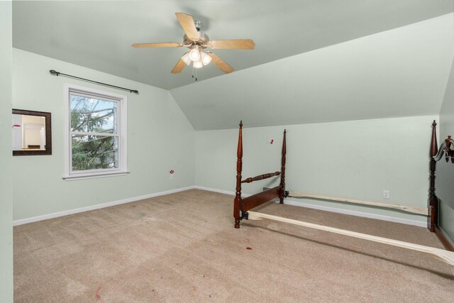 bonus room with ceiling fan, lofted ceiling, and light carpet