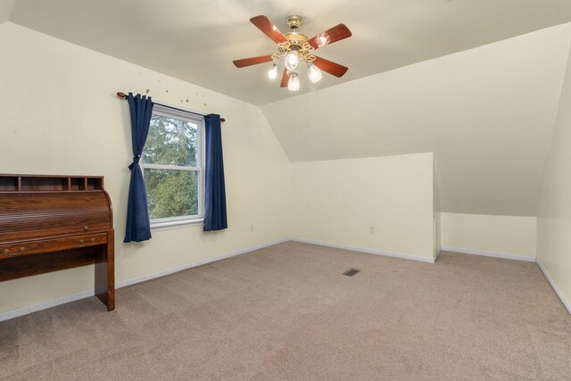 additional living space with ceiling fan, light carpet, and vaulted ceiling