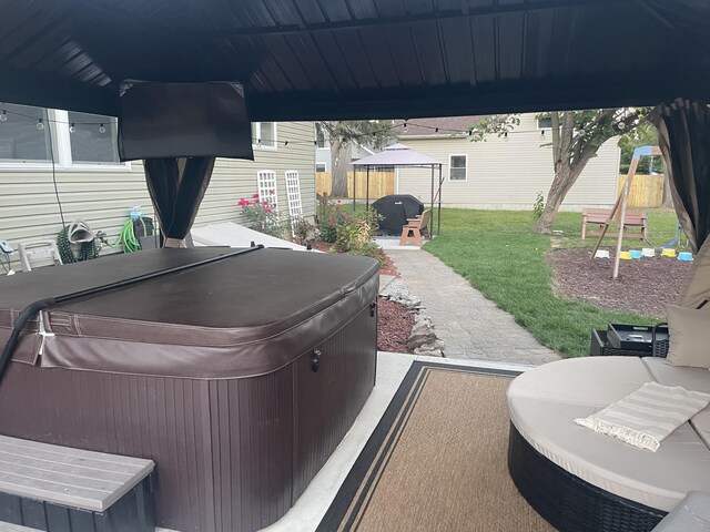 view of patio / terrace with a hot tub