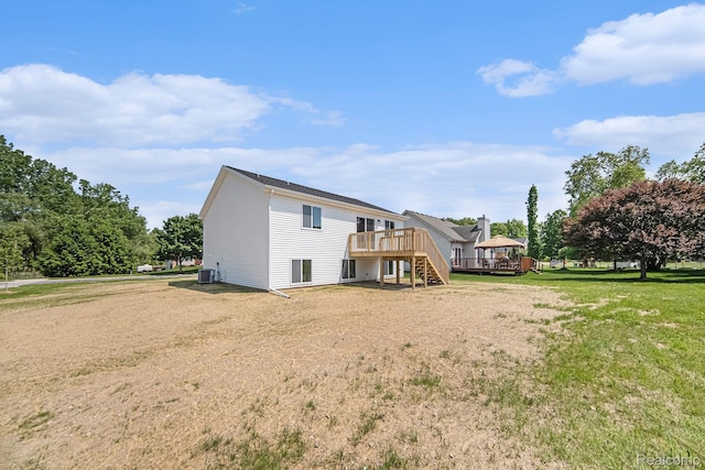 172 Woodland Way, Manchester, MI 48158 - back of property with stairway, a deck, central air condition unit, and a lawn
