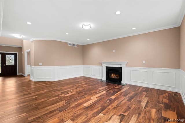 unfurnished living room featuring crown molding and dark wood-type flooring