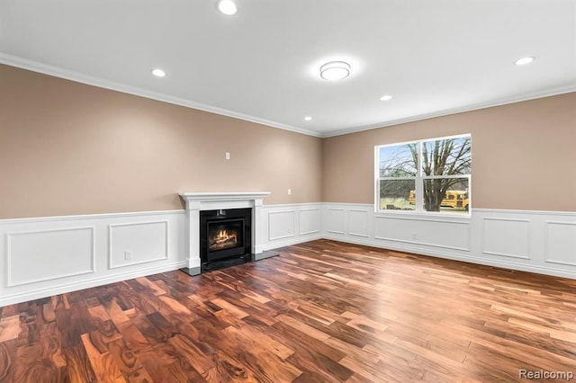 unfurnished living room featuring crown molding and hardwood / wood-style floors