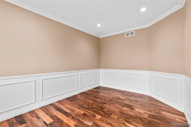 spare room with dark hardwood / wood-style floors and ornamental molding