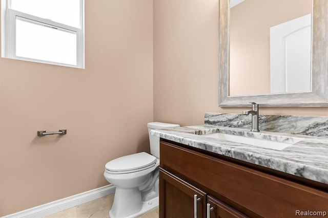 bathroom with tile patterned floors, vanity, and toilet