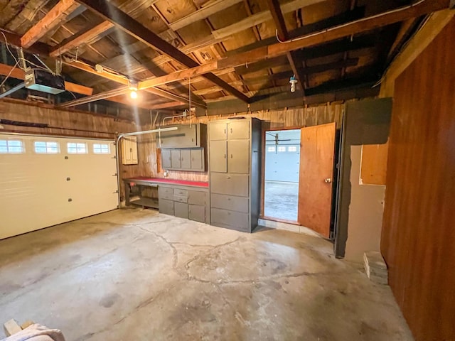 garage with a workshop area and a garage door opener