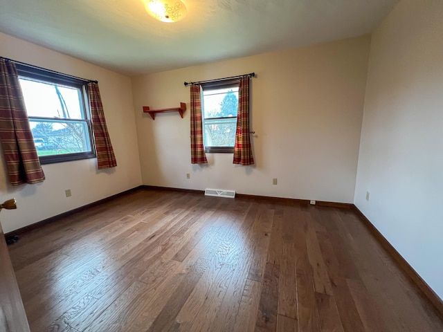 unfurnished room featuring hardwood / wood-style flooring