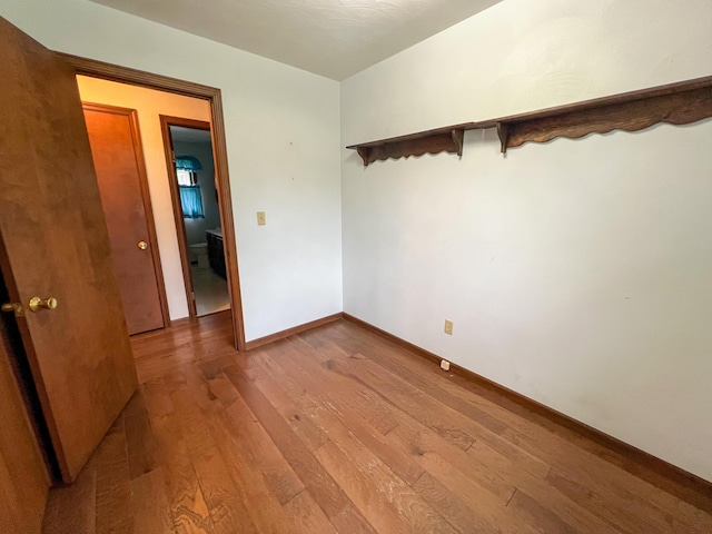 spare room with wood-type flooring