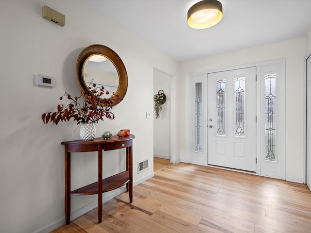 foyer with light hardwood / wood-style floors