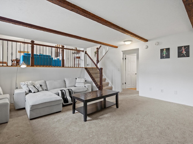 living room featuring beam ceiling and carpet floors