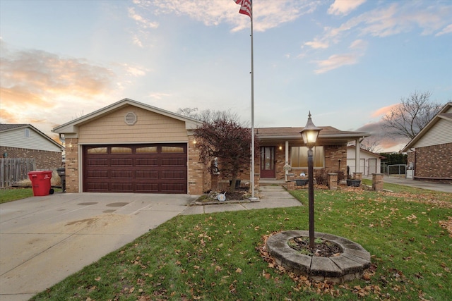 view of front of home featuring a lawn and a garage