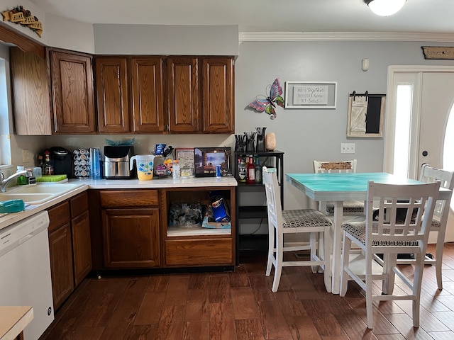 kitchen featuring dishwasher, crown molding, sink, and dark wood-type flooring