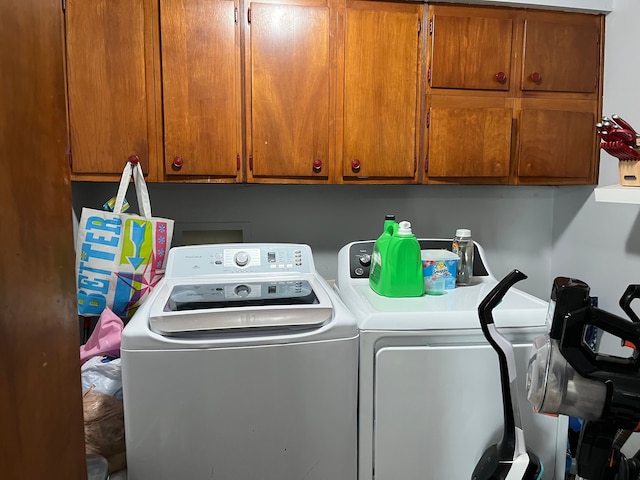 laundry area featuring washer and dryer and cabinets