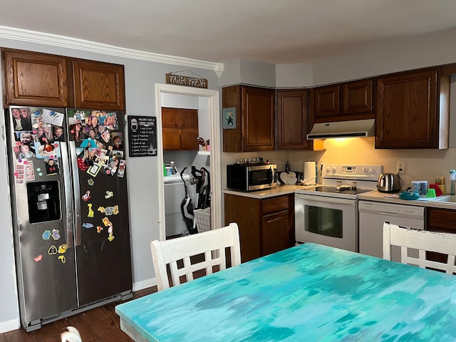 kitchen featuring dark hardwood / wood-style flooring, stainless steel appliances, and washing machine and dryer