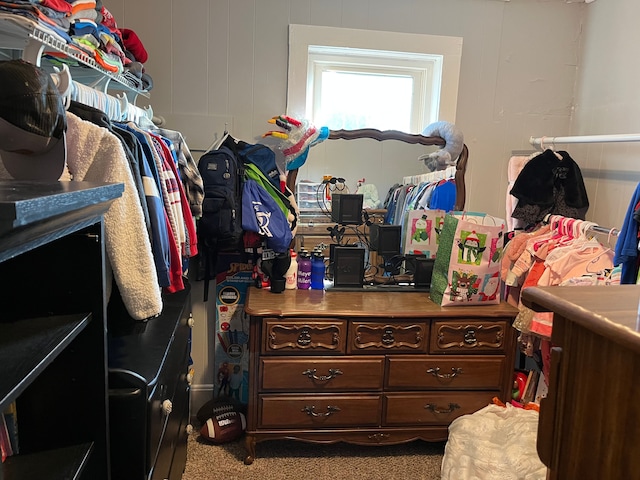 walk in closet featuring carpet flooring