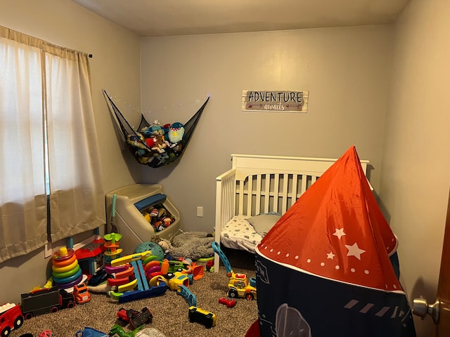 carpeted bedroom with a crib