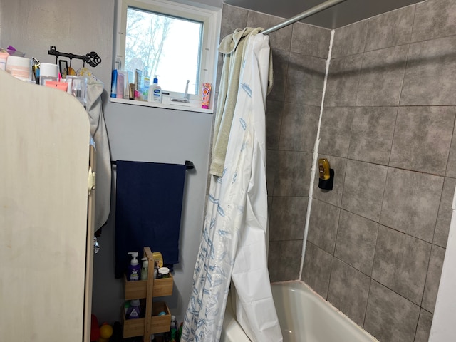 bathroom with shower / bath combo with shower curtain