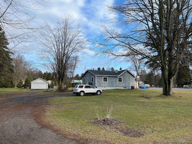 exterior space featuring an outdoor structure and a front lawn