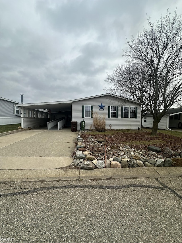 view of front of house with a carport and cooling unit