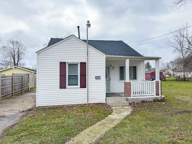 bungalow-style home featuring a porch and a front lawn