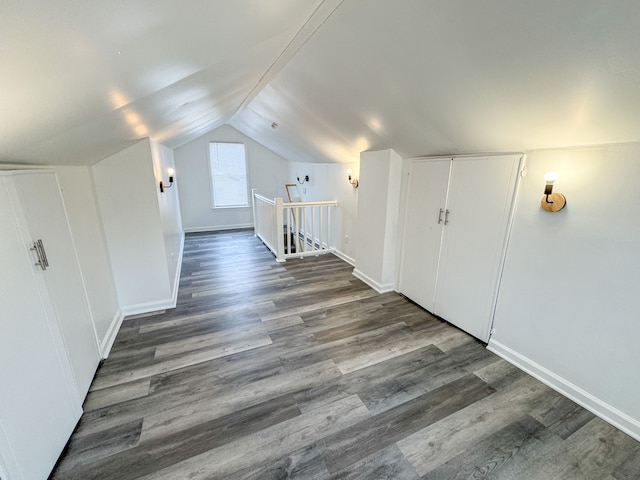 bonus room with dark hardwood / wood-style flooring and lofted ceiling