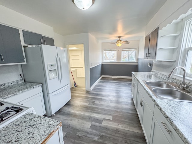 kitchen featuring white cabinets, ceiling fan, and sink