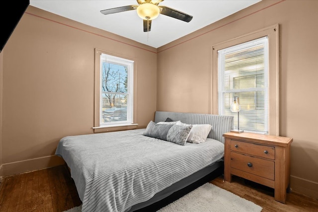 bedroom featuring ceiling fan and dark hardwood / wood-style floors